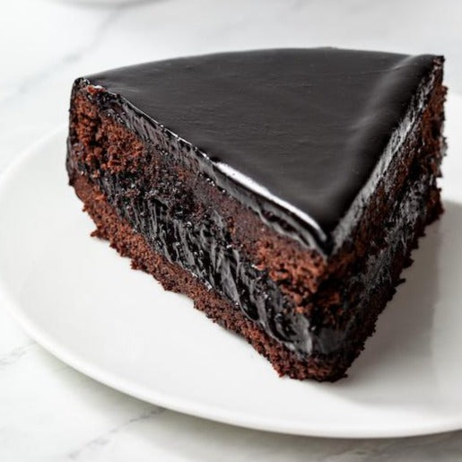 a piece of chocolate blackout cake on a plate from william greenberg desserts