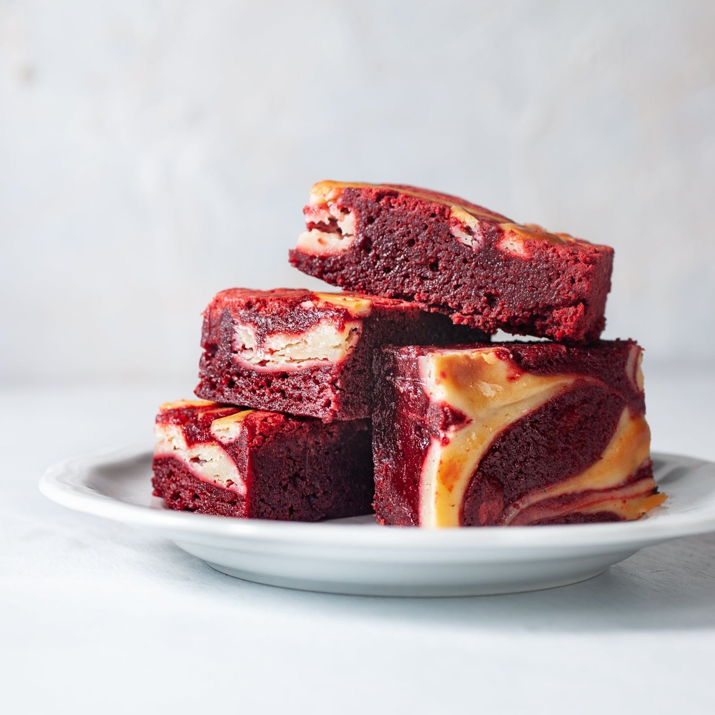 Plate of four red velvet brownies from William Greenberg desserts