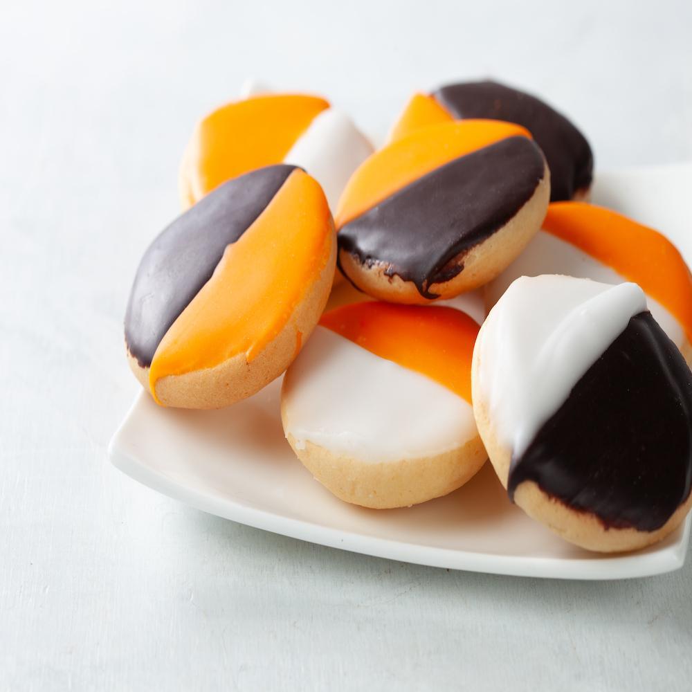 Orange brown and white cakey cookies on a white plate.
