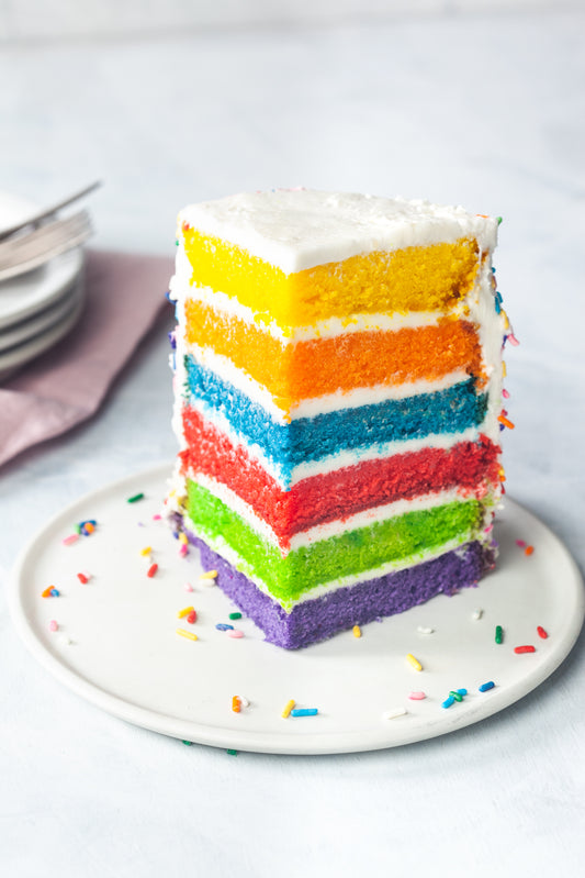 Rainbow cake slice multiple layers with buttercream frosting