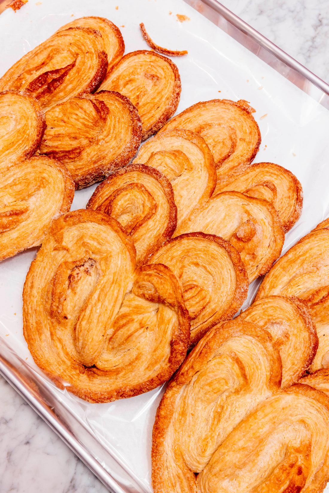Palmiers or elephant ear pastries on a plate.