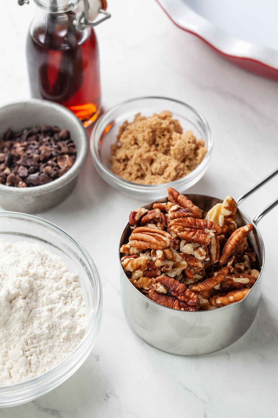 vanilla, pecans, brown sugar, and flour in bowls to show the quality of ingredients