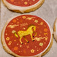 Decorative shortbread cookie with a horse illustration and '2026' on a red background