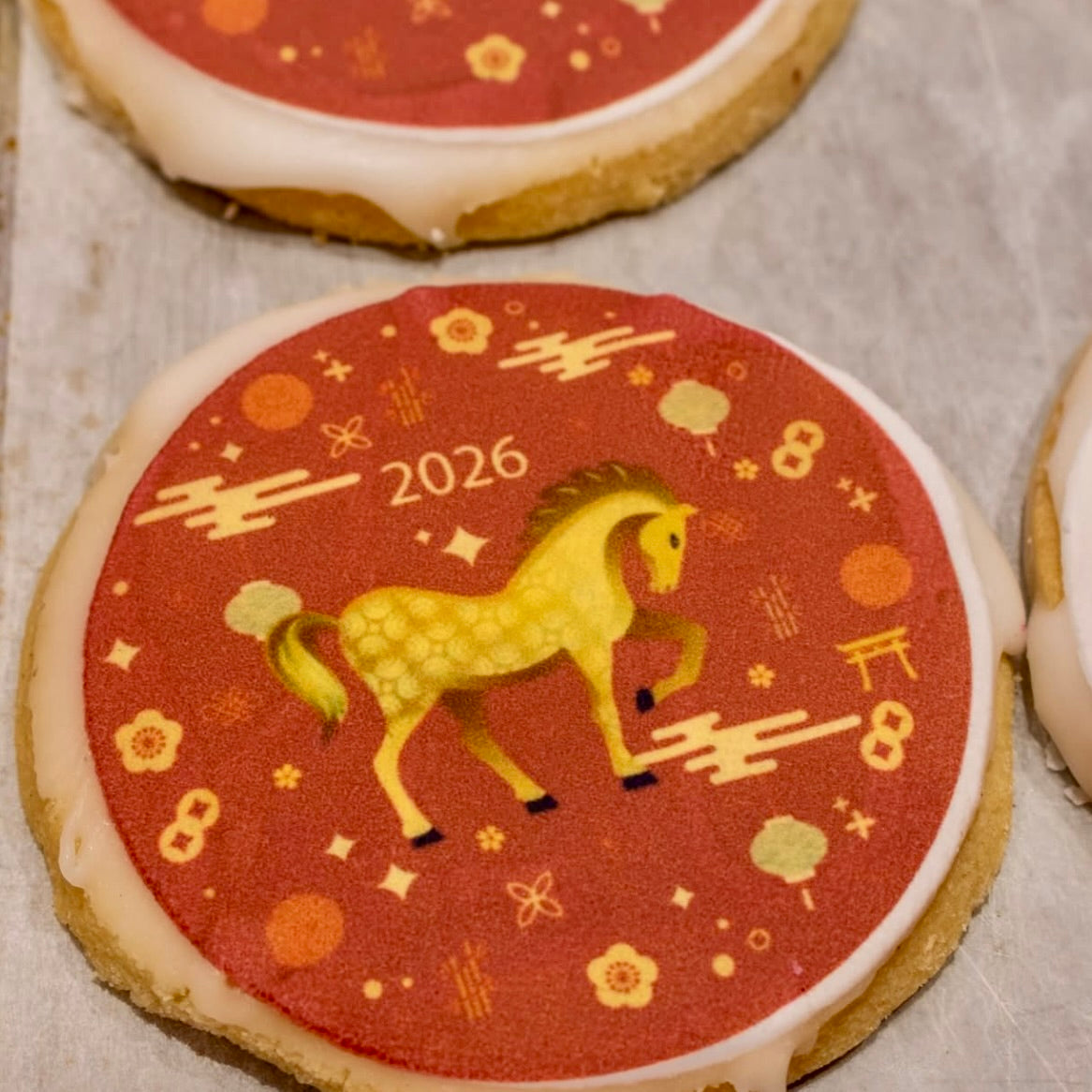 Decorative shortbread cookie with a horse illustration and '2026' on a red background