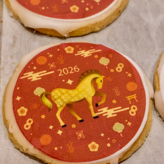 Decorative shortbread cookie with a horse illustration and '2026' on a red background