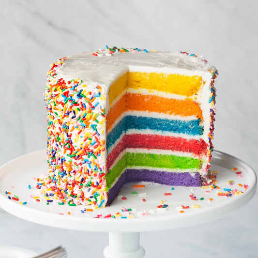 Rainbow cake with buttercream icing and sprinkles