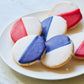 Plate of William Greenberg Desserts Black & White cookies with red, white, and blue icing on a white plate
