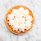 individual lemon meriangue tart with white cream on a marble surface