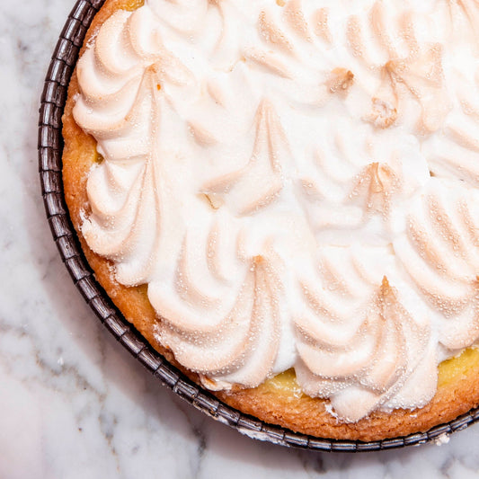 lemon meriangue Pie with meringue topping on a marble surface