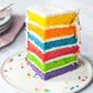 Rainbow cake slice with 6 colorful layers and butter cream frosting